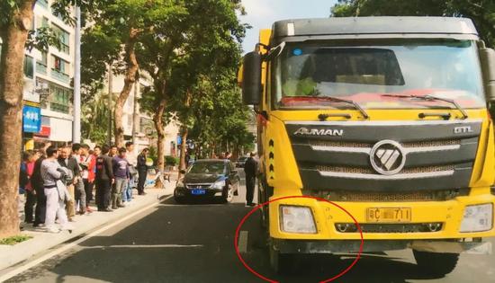 大貨車司機站在人群中，顫抖著撥打電話。