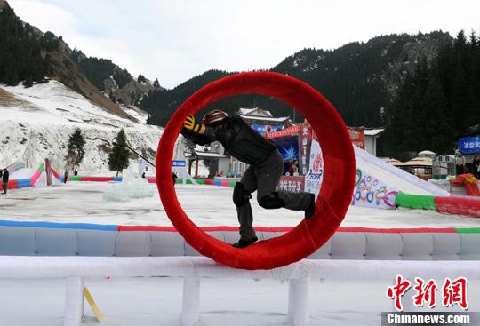 資料圖：12月29日，烏魯木齊第九屆絲綢之路冰雪風情節(jié)最大亮點“冰雪大沖關”，在天山大峽谷景區(qū)如期舉行。圖為一位市民正在挑戰(zhàn)冰上風火輪關卡。<a target='_blank'  data-cke-saved- ><p  align=